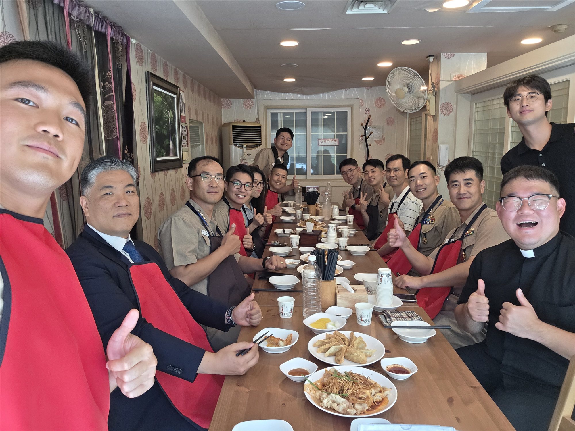 Group photograph at a shared meal