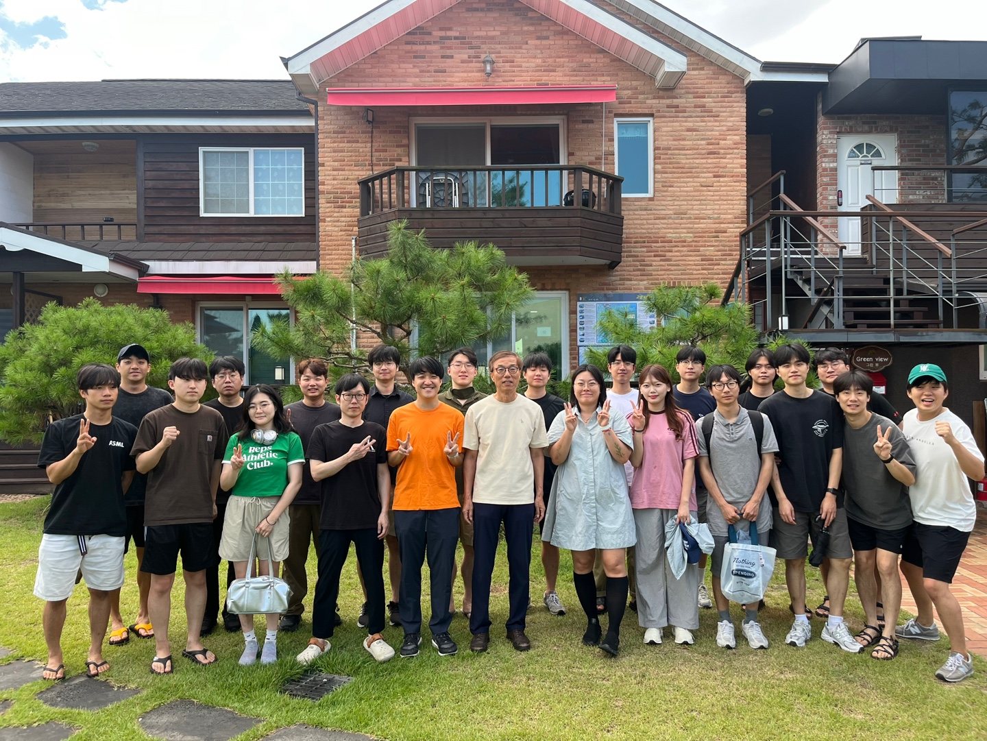 Lab group outdoors in front of a brick building