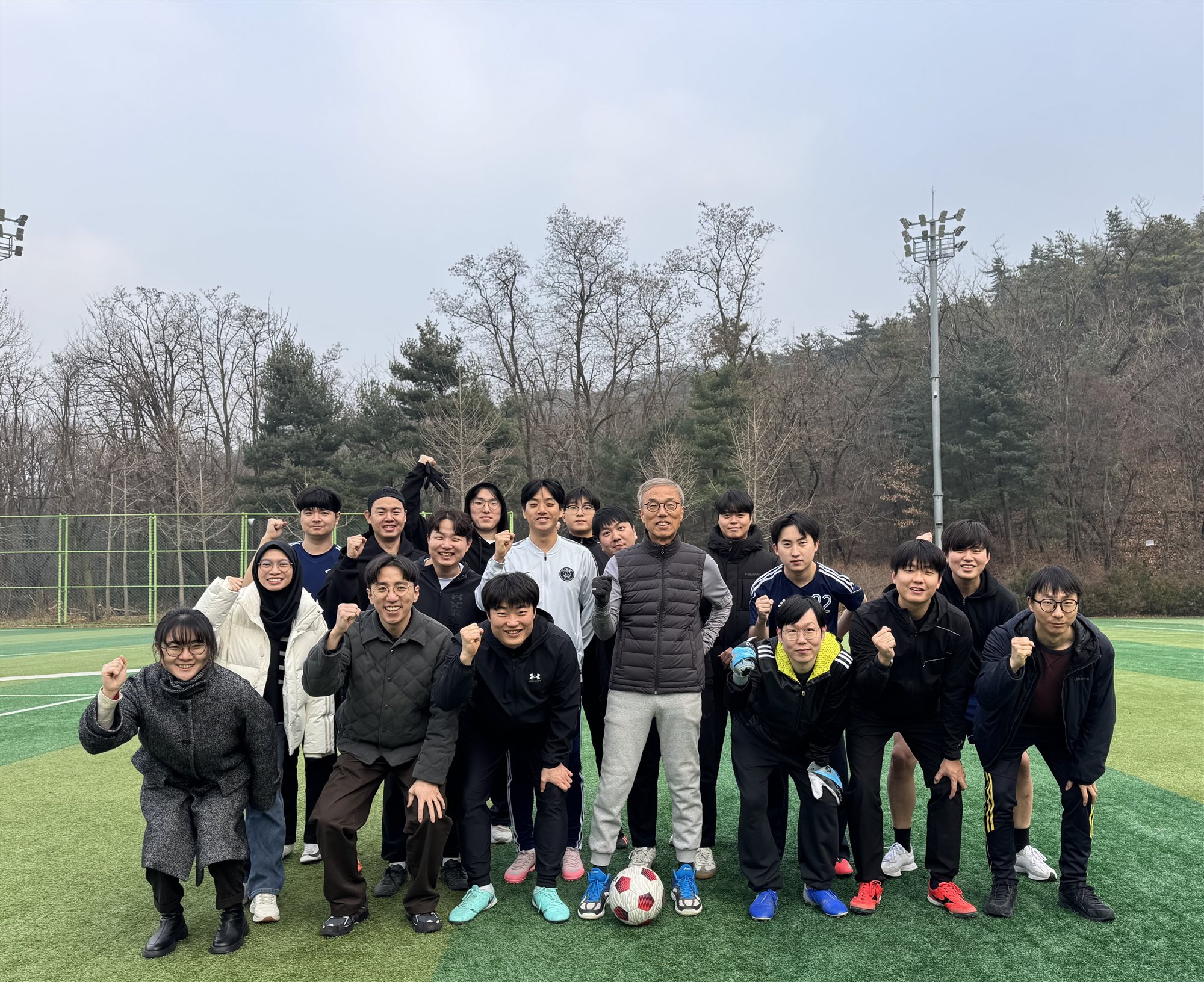Labmates gathered on a sports field