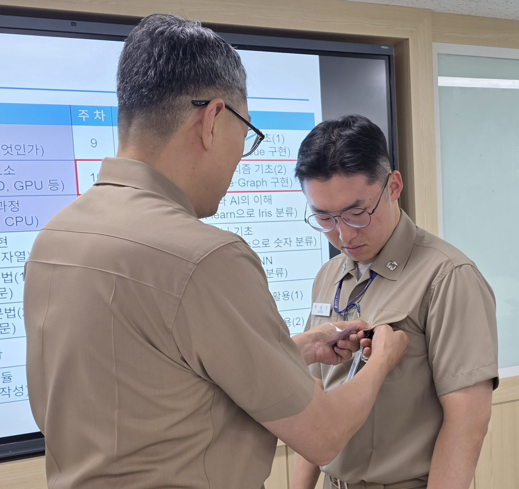 Receiving the faculty insignia from the head of the Academy's science division following the evaluation